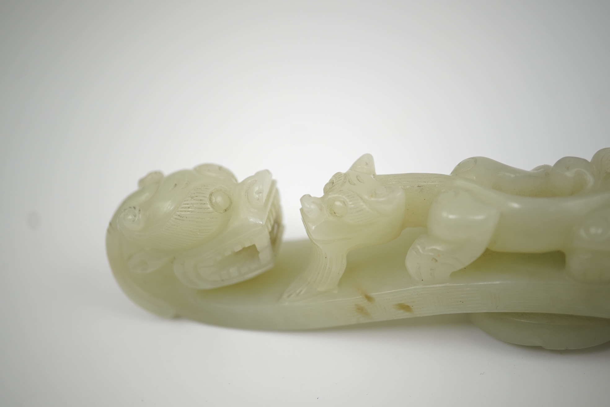 A Chinese pale celadon jade 'dragon' belt hook, 18th/19th century